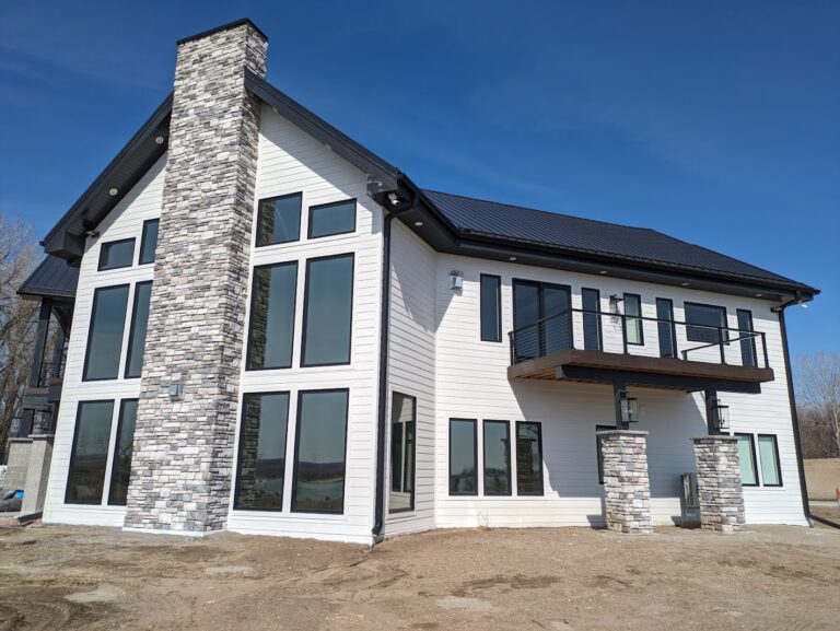 Exterior of a modern home with large windows in Dakota Dunes