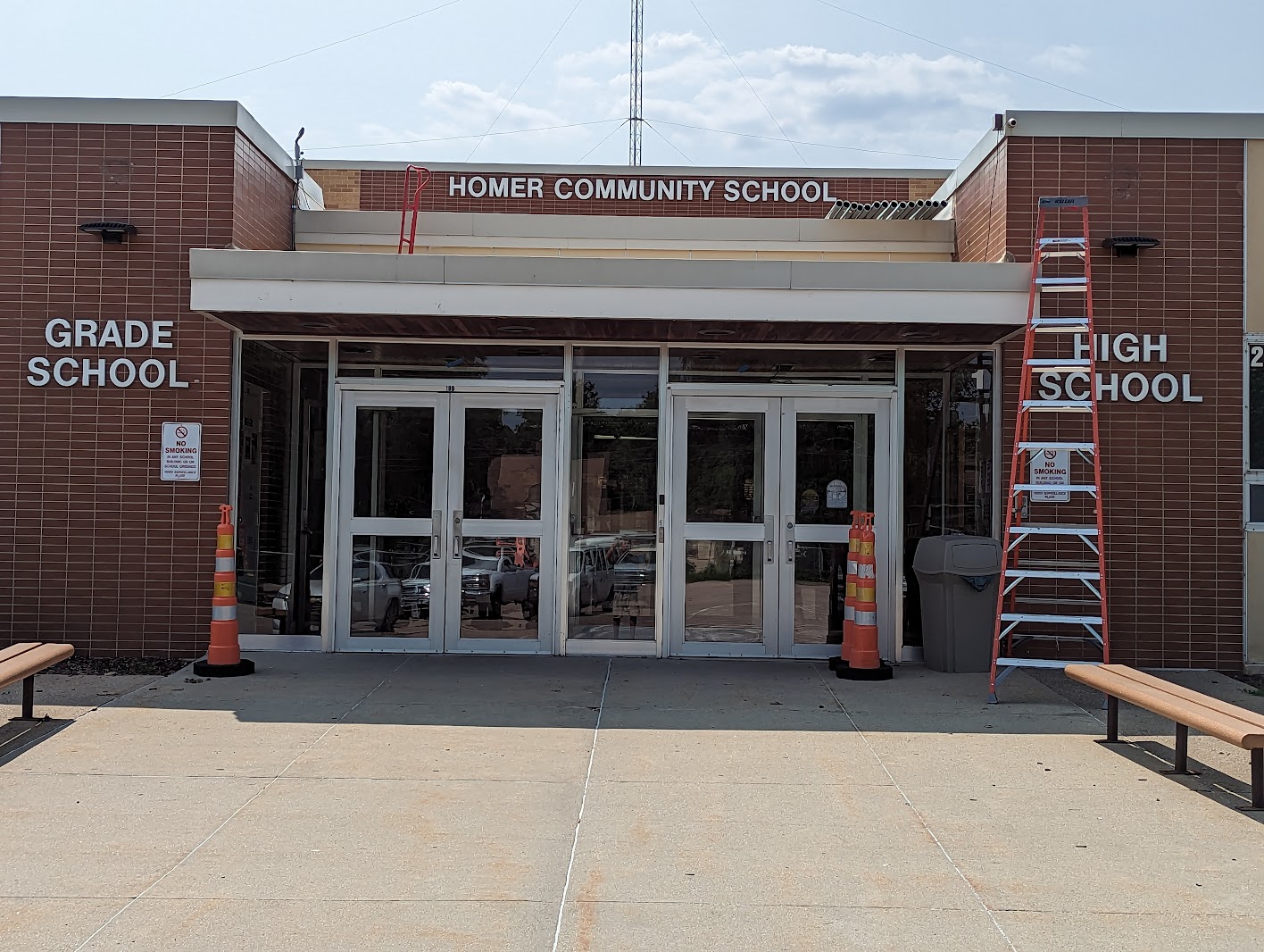 Homer Community School glass entrance with ladders and cones during work