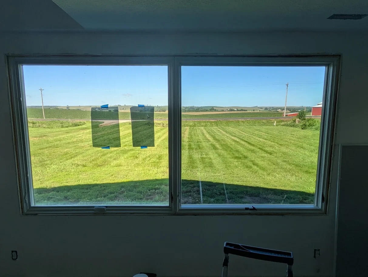 VE35 Low-E window film samples taped to a window in Merrill, Iowa