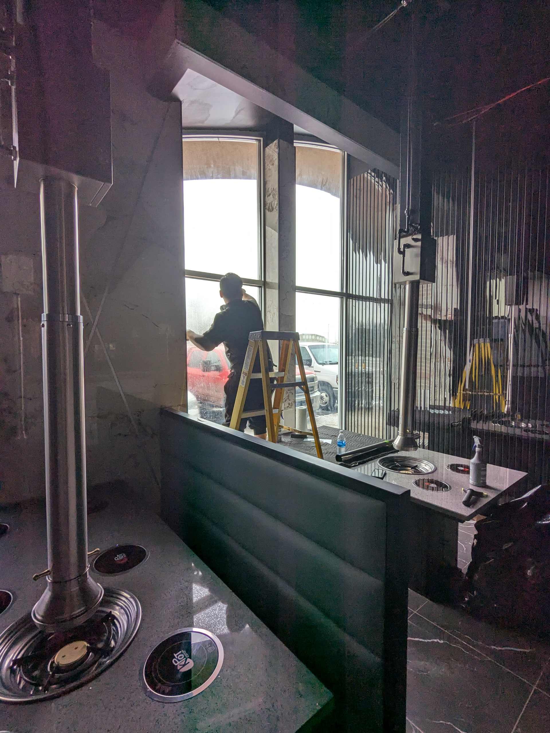 Restaurant storefront glass seen from inside during window film installation