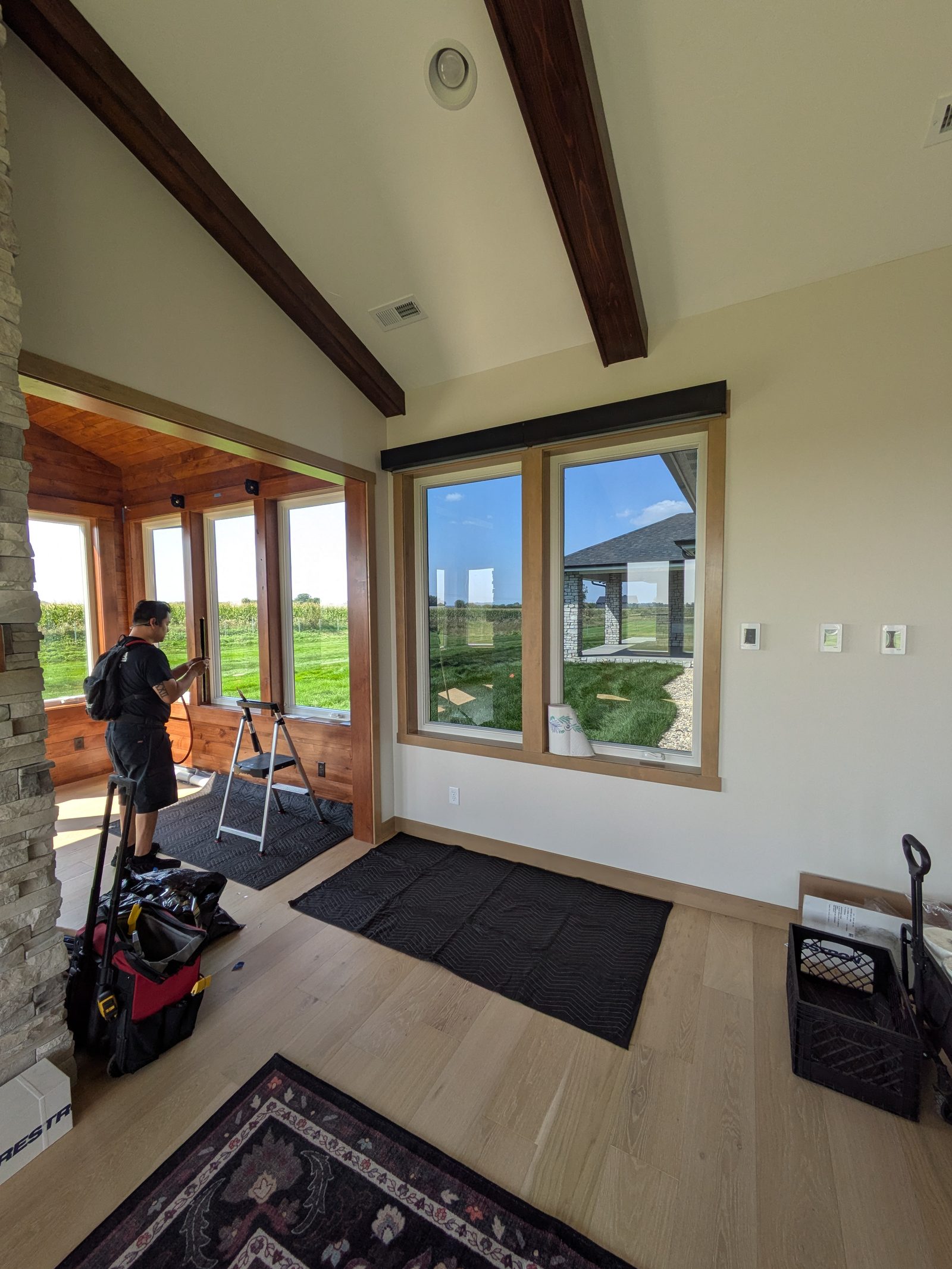 Installer working on sunny living room windows